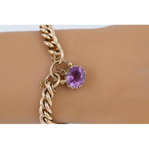 311 - A CURB LINK BRACELET, 9ct gold with amethyst set clasp