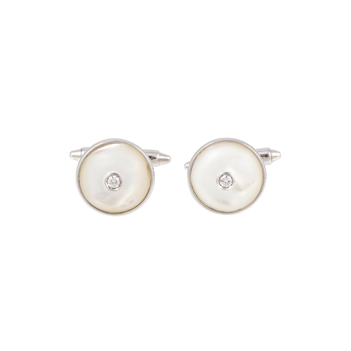 343 - A PAIR OF MOTHER OF PEARL AND DIAMOND CUFFLINKS, of circular form, mounted in 18ct white gold