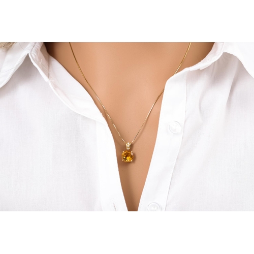 344 - A CITRINE AND DIAMOND PENDANT, the circular citrine set to a diamond set bail, mounted in 18ct yello... 