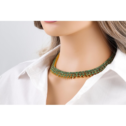 36 - AN  EMERALD FRINGE NECKLACE, of Eastern style, set with circular and pear shaped stones, (tests as 2... 