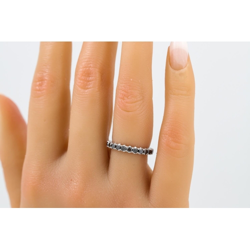 393 - A DIAMOND ETERNITY RING, the black diamonds mounted in 18ct white gold. Estimated: weight of diamond... 