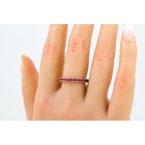 396 - A RUBY ETERNITY RING, the circular stones mounted in 18ct white gold. Estimated: weight of rubies: 2... 