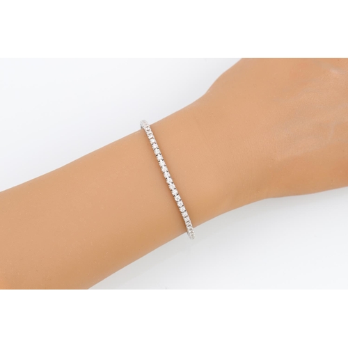 398 - A DIAMOND LINE BRACELET, the brilliant cut diamonds mounted in 18ct white gold. Estimated: weight of... 