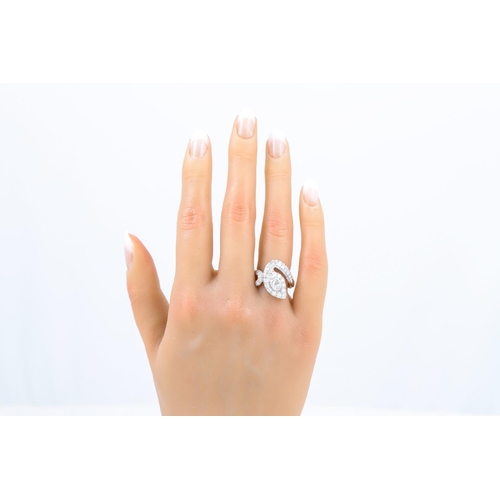 430 - A DIAMOND RING, modelled as a snake, the old cut collet set centre diamond to a pavé diamond surroun... 