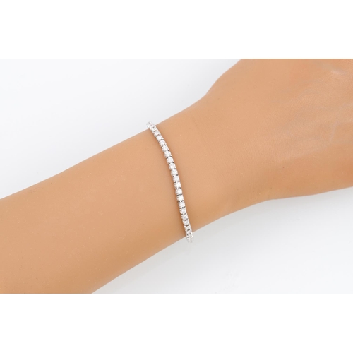 440 - A DIAMOND LINE BRACELET, the brilliant cut diamonds mounted in 18ct white gold. Estimated: weight of... 