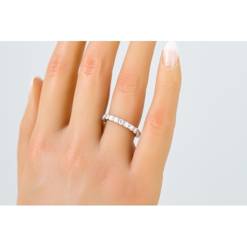 446 - A DIAMOND ETERNITY RING, the brilliant cut diamonds mounted in white gold. Estimated: weight of diam... 