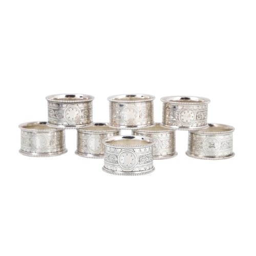 536 - A CASED SET OF EIGHT SILVER PLATED NAPKIN RINGS, together with a cased set of six silver plated menu... 