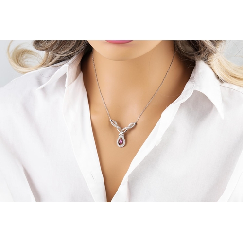 79 - A DIAMOND AND PINK SAPPHIRE PENDANT, mounted in white gold on a white gold chain