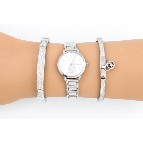 88 - A MICHAEL KORS WRIST WATCH, together with two bangles in a pouch