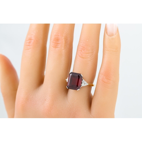 95 - A GARNET AND DIAMOND DRESS RING, the octagonal garnet to diamond shoulders, mounted in 18ct yellow g... 