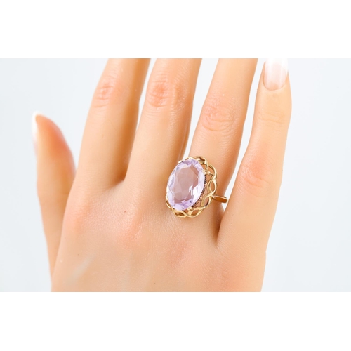 98 - AN AMETHYST DRESS RING, the oval amethyst mounted in 9ct yellow gold, size N