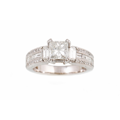 421 - A DIAMOND DRESS RING, the centre princess cut diamond flanked by baguette cut side stones, the shoul... 