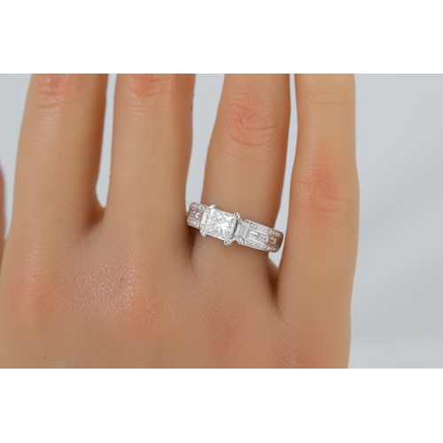 421 - A DIAMOND DRESS RING, the centre princess cut diamond flanked by baguette cut side stones, the shoul... 