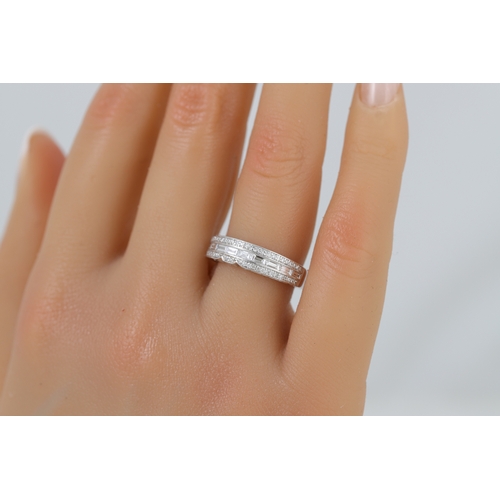 422 - A DIAMOND SET BAND RING, set with baguette and round brilliant cut stones mounted in 18ct white gold... 