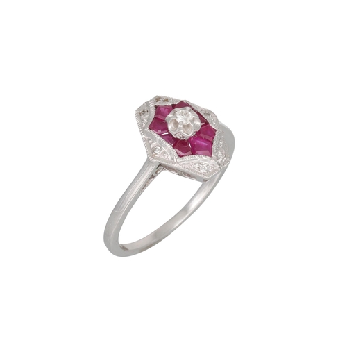 113 - A DIAMOND AND RUBY CLUSTER RING, the hexagonal shaped ring with raised central diamond, mounted in 9... 