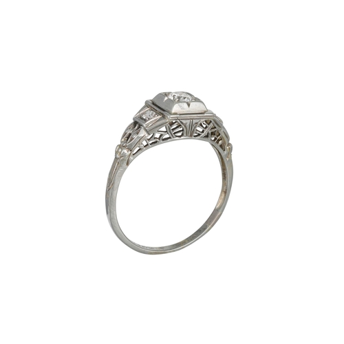 129 - AN ART DECO STYLE DRESS RING, set with a diamond to centre, in 18ct white gold, size M - N