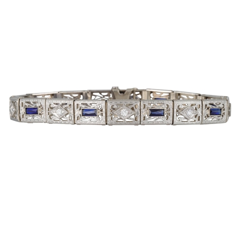 136 - A LATE ART DECO DIAMOND AND STONE SET COCKTAIL BRACELET, of geometric and articulated design, mounte... 