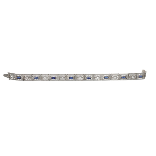 136 - A LATE ART DECO DIAMOND AND STONE SET COCKTAIL BRACELET, of geometric and articulated design, mounte... 