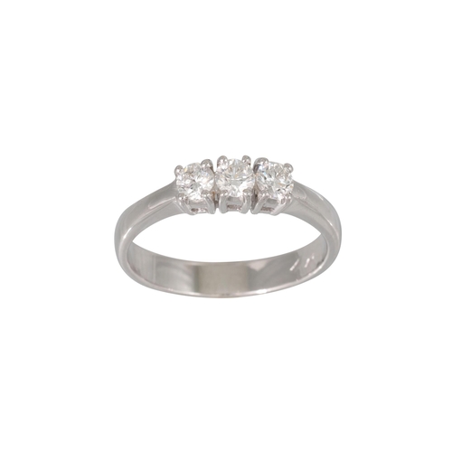 147 - A THREE STONE DIAMOND RING, the brilliant cut diamodns mounted in 18ct white gold. Estimated: weight... 