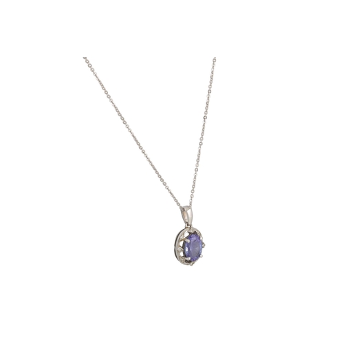 17 - A TANZANITE AND DIAMOND CLUSTER PENDANT, in 9ct white gold, on an 18