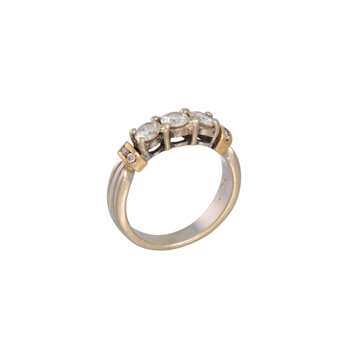 18 - A THREE STONE DIAMOND RING, the brilliant cut diamonds mounted in 18ct gold. Estimated: weight of di... 