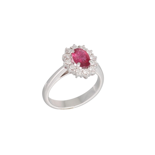 198 - A RUBY AND DIAMOND CLUSTER RING, the oval ruby to round brilliant cut diamond surround, mounted in 1... 