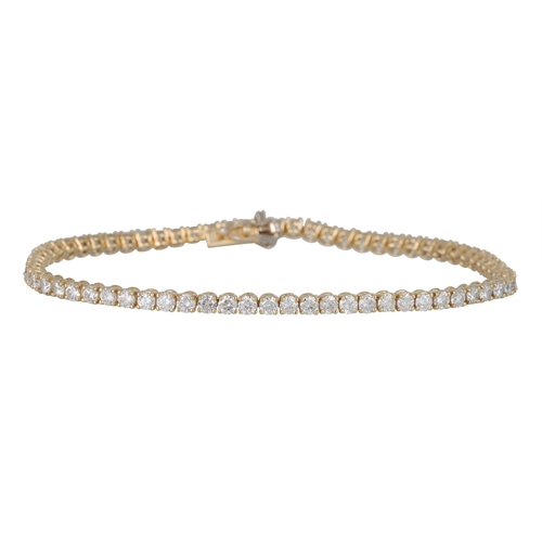 201 - A DIAMOND LINE BRACELET, the brilliant cut diamonds mounted in 18ct yellow gold, 7