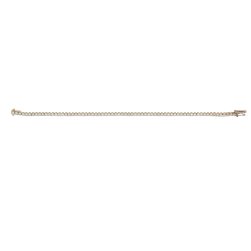 201 - A DIAMOND LINE BRACELET, the brilliant cut diamonds mounted in 18ct yellow gold, 7