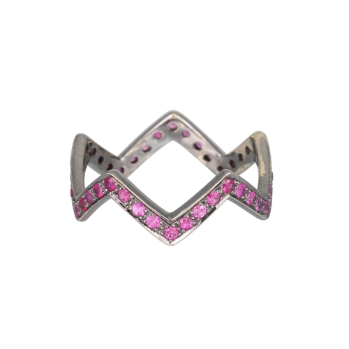 214 - A RUBY SHAPED BAND RING, in zig-zag form, mounted in 18ct white gold, black rhodium plated.