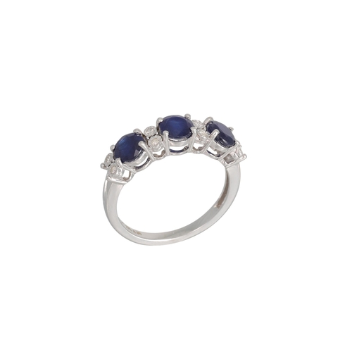 221 - A SAPPHIRE AND DIAMOND RING, the circular sapphires set between diamond points, mounted in white gol... 