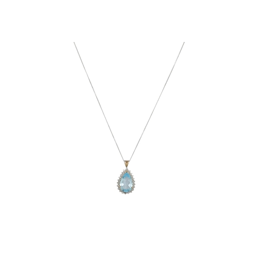 23 - A BLUE TOPAZ AND DIAMOND SET PENDANT, the large pear shaped topaz to diamond surround, on a white go... 