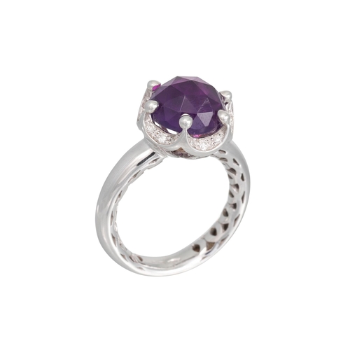 247 - AN AMETHYST AND DIAMOND DRESS RING, the mixed cut amethyst to a shaped diamond surround in 18ct whit... 