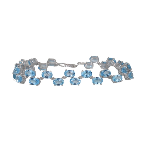 26 - A BLUE TOPAZ AND DIAMOND BRACELET, the oval topaz to diamond spacers mounted in white gold, 18 cm