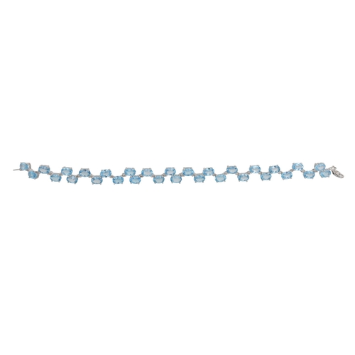 26 - A BLUE TOPAZ AND DIAMOND BRACELET, the oval topaz to diamond spacers mounted in white gold, 18 cm