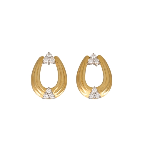 286 - A PAIR OF DIAMOND EARRINGS, each horseshoe shaped panel set with two diamond trios, in gold. Estimat... 