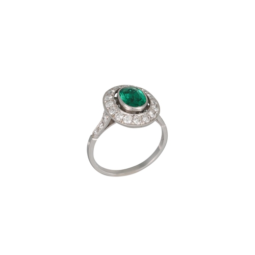 297 - AN EMERALD AND DIAMOND CLUSTER RING, of oval form, the oval emerald to a brilliant cut diamond surro... 