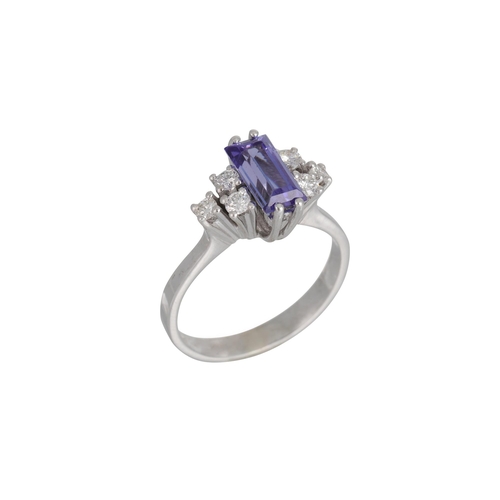 319 - A TANZANITE AND DIAMOND RING, the rectangular tanzanite to diamond shoulders, in 14ct white gold. Es... 