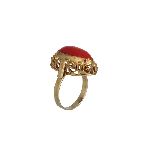 323 - A RED CORAL RING, the cabochon stone mounted in 14ct gold, size M