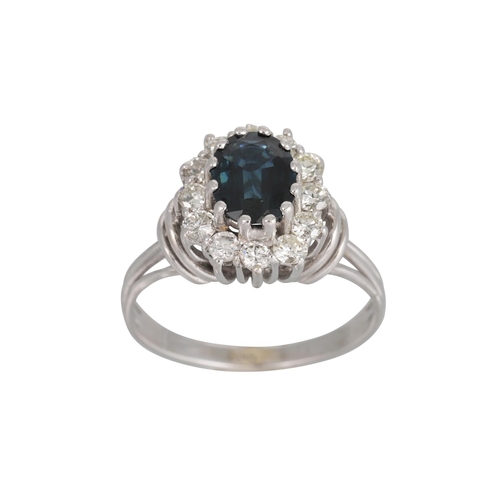 324 - A SAPPHIRE AND DIAMOND CLUSTER RING, the oval sapphire to brilliant cut diamond surround, mounted in... 