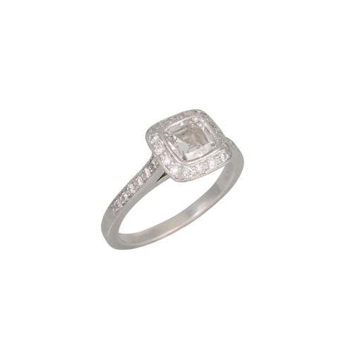 338 - A TIFFANY DIAMOND CLUSTER RING, the cushion cut diamond to a brilliant cut diamond surround and shou... 