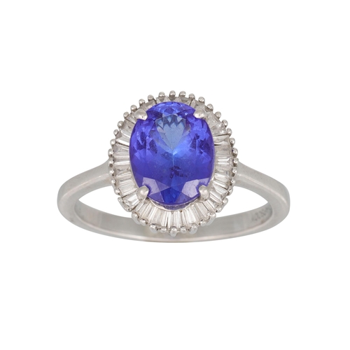 356 - A TANZANITE AND DIAMOND CLUSTER RING, the oval tanzanite to baguette diamond surround, mounted in pl... 