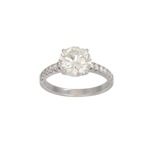 388 - A DIAMOND SOLITAIRE RING, the brilliant cut diamond to diamond shoulders, mounted in 18ct white gold... 