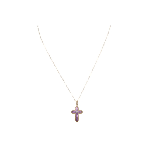 40 - AN AMETHYST AND DIAMOND CROSS, the centre diamond to channel set amethysts, mounted in yellow gold o... 