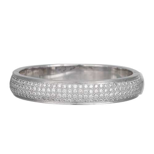 401 - A DIAMOND SET BANGLE, set with four rows of brilliant cut diamonds, in 18ct white gold. Estimated: w... 