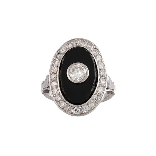 409 - AN ONYX AND DIAMOND PLAQUE RING, the old cut diamond within an onyx plaque to a diamond surround. Fr... 