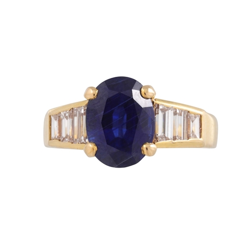 410 - A SAPPHIRE SINGLE STONE RING, the oval sapphire to baguette shoulders. French assay mark for 18ct go... 