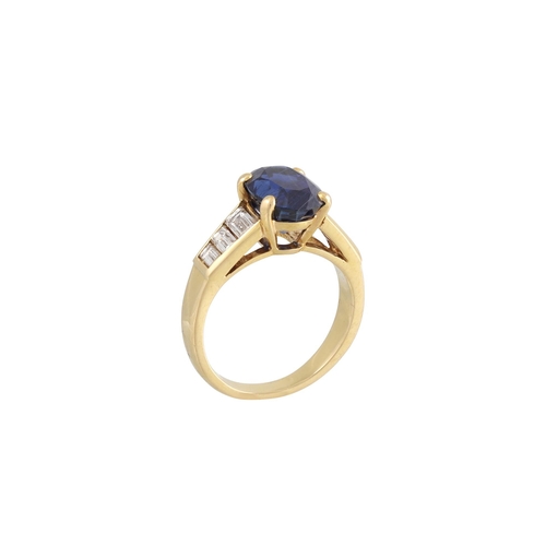 410 - A SAPPHIRE SINGLE STONE RING, the oval sapphire to baguette shoulders. French assay mark for 18ct go... 