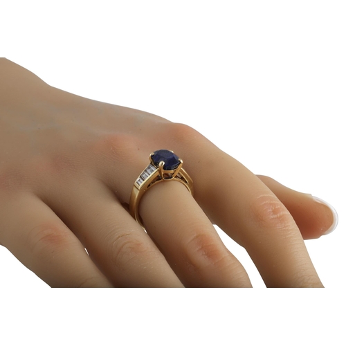 410 - A SAPPHIRE SINGLE STONE RING, the oval sapphire to baguette shoulders. French assay mark for 18ct go... 