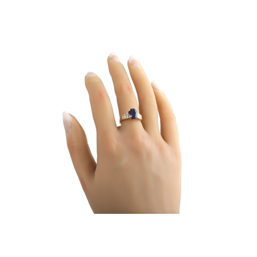 410 - A SAPPHIRE SINGLE STONE RING, the oval sapphire to baguette shoulders. French assay mark for 18ct go... 