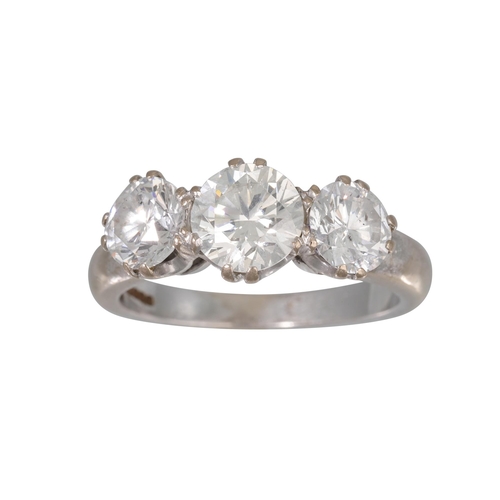 421 - A THREE STONE DIAMOND RING, the brilliant cut diamonds mounted in 18ct white gold. Estimated: weight... 